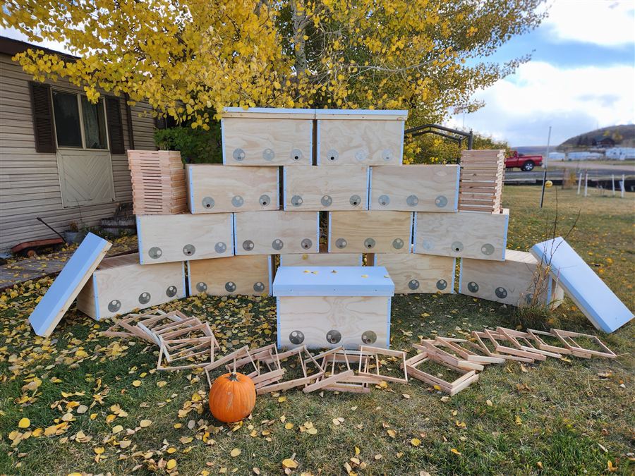 Thirty-one hives stacked at the partner CNC shop, awaiting pickup