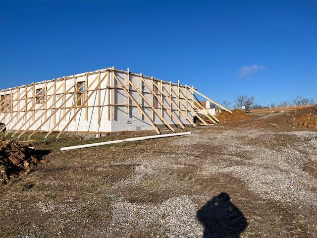 Full-height white ICF foam walls standing with diagonal timber bracing before the concrete pour.